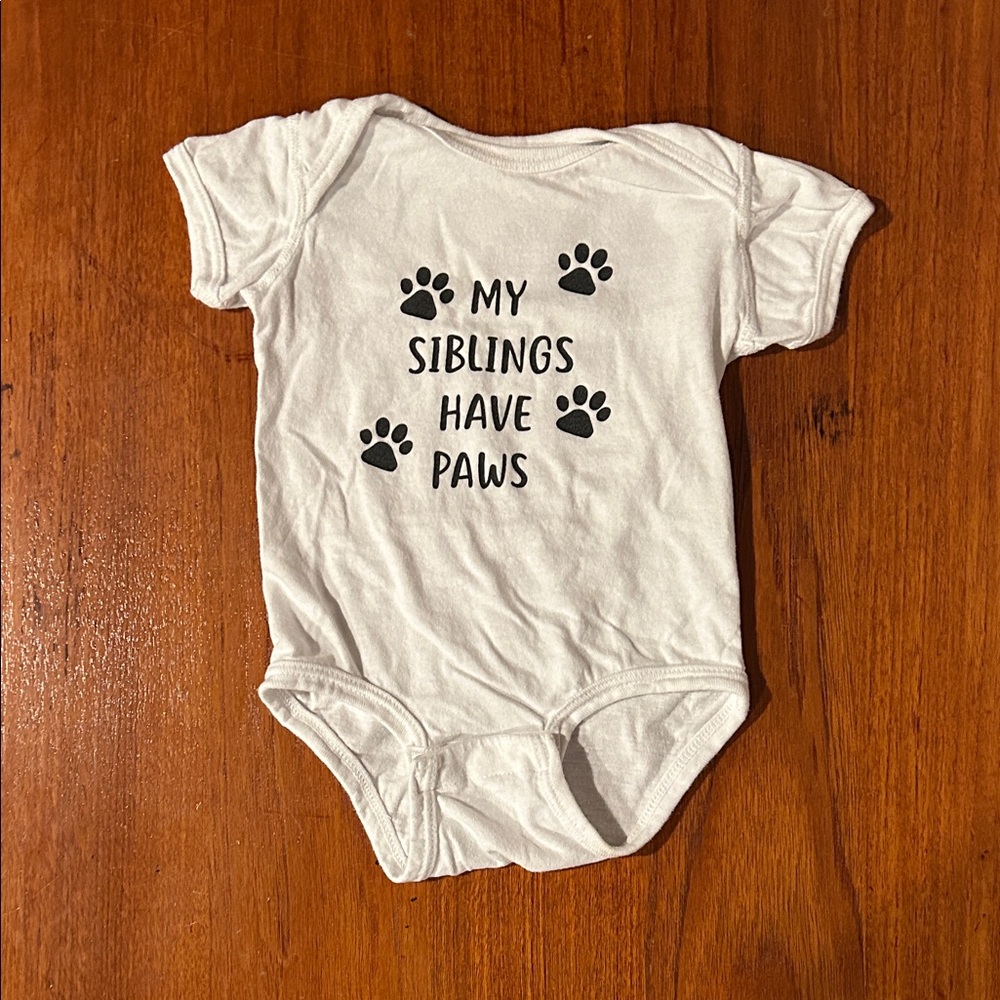 White Baby Onesie with Paw Print Design